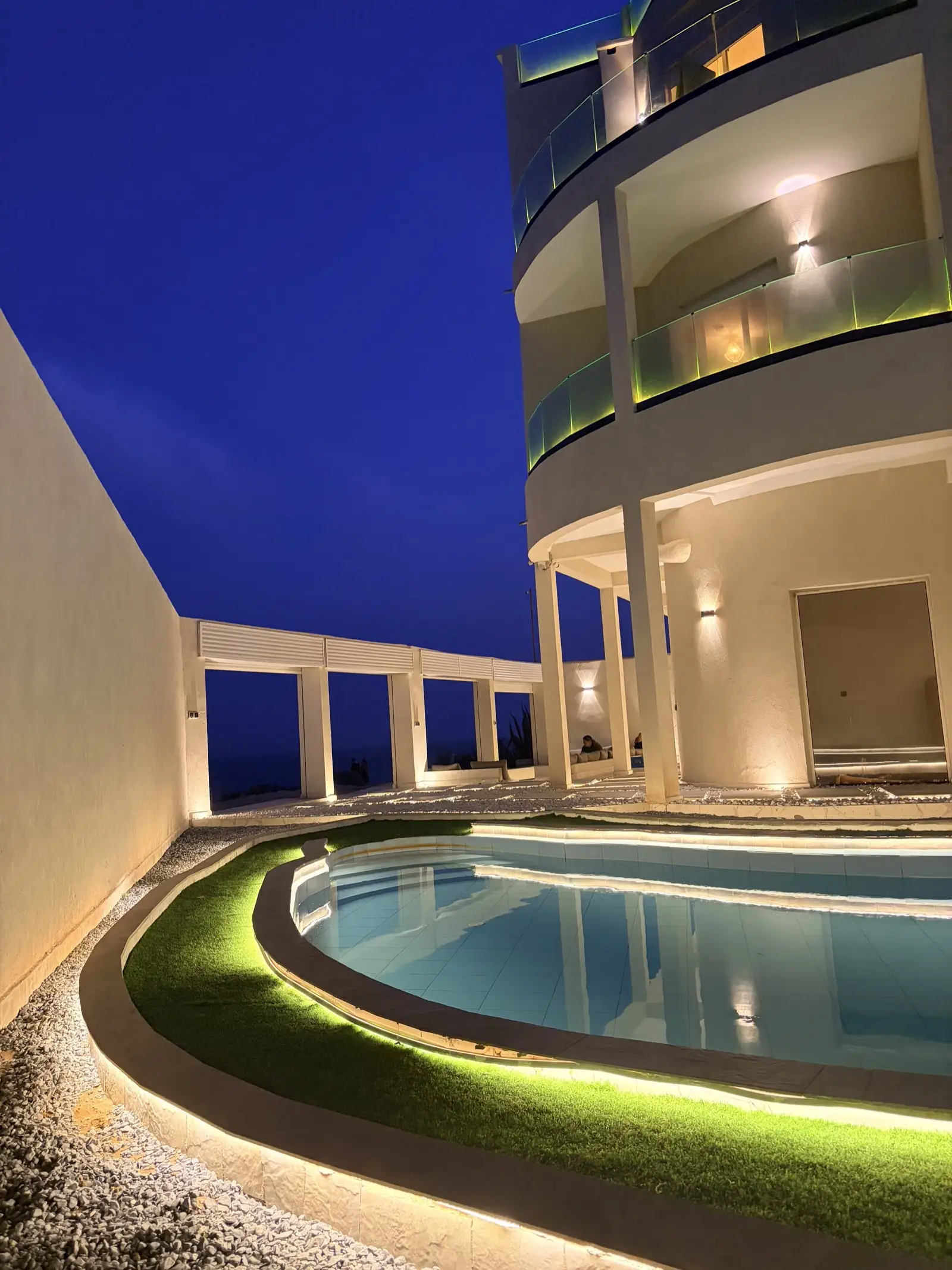 The pool · lit for the evening